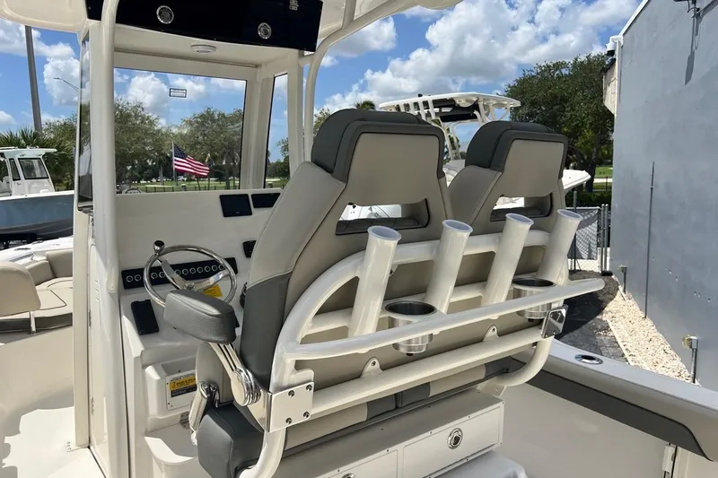 Slide: The Image of 2026 Key West 219 FS boat interior with dual seats and rod holders. - 31