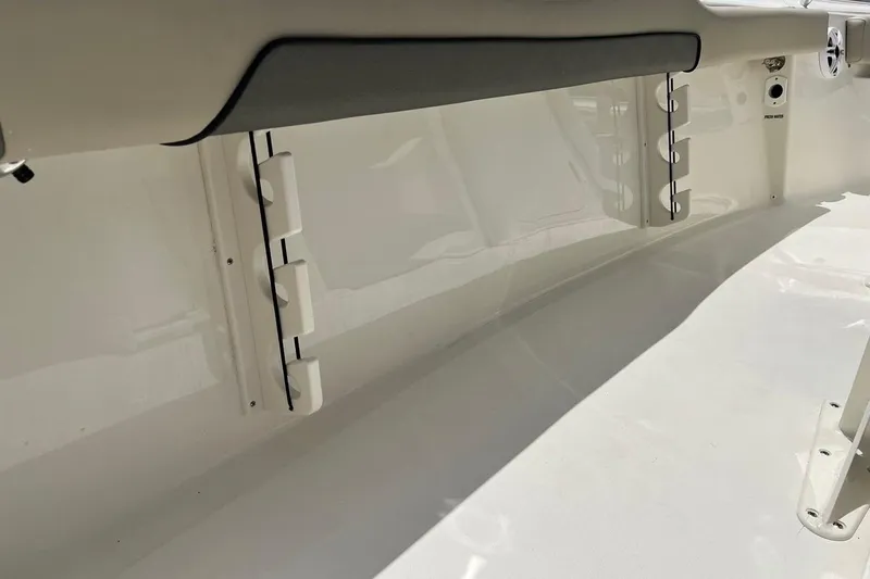 Slide: The Image of 2026 Key West 219 FS boat interior with rod holders and clean white finish. - 33
