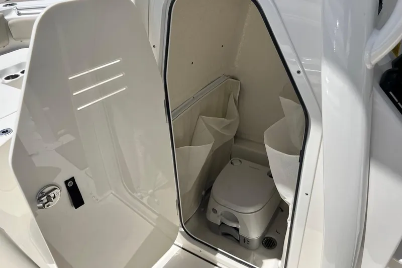 Slide: The Image of 2026 Key West 219 FS boat interior with compact marine toilet. - 36