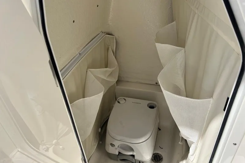 Slide: The Image of Interior of 2026 Key West 219 FS boat with compact marine toilet. - 37