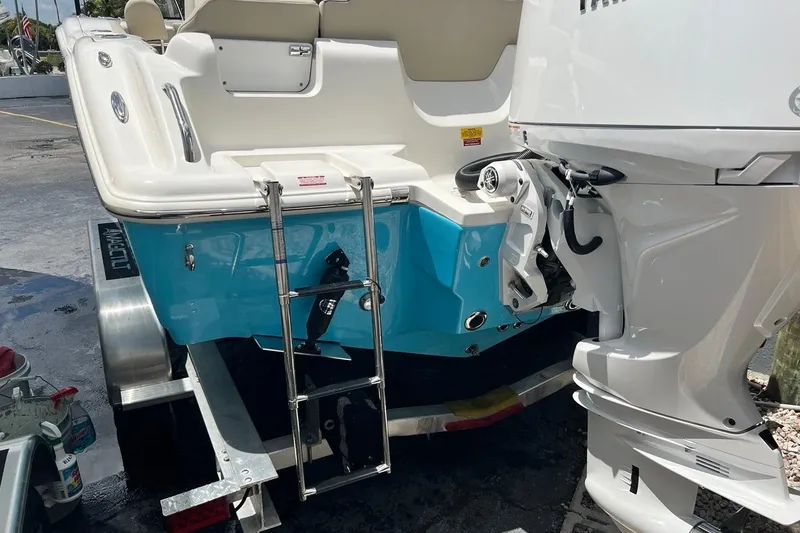 Slide: The Image of 2026 Key West 219 FS boat with outboard motor and swim ladder. - 6