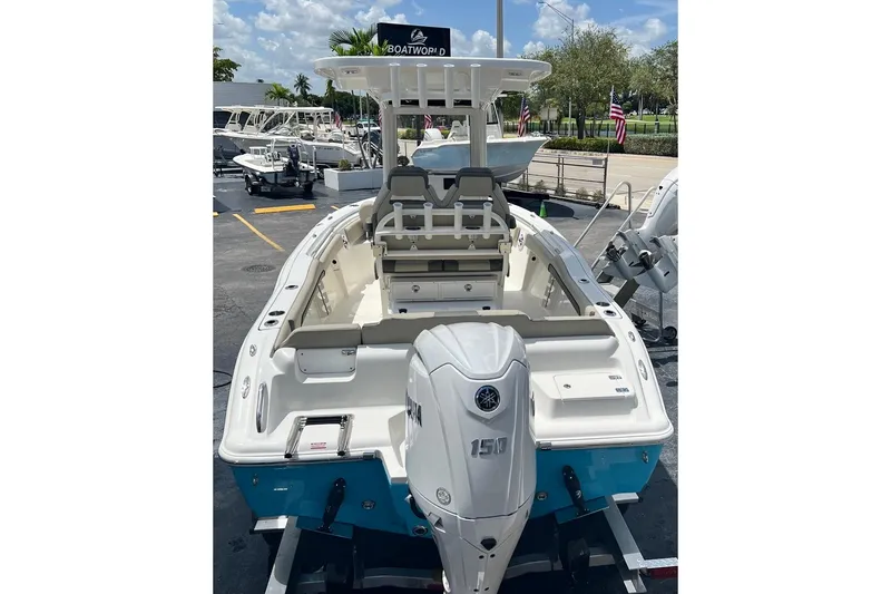 Slide: The Image of 2026 Key West 219 FS boat with Yamaha 150 engine, displayed outdoors. - 8