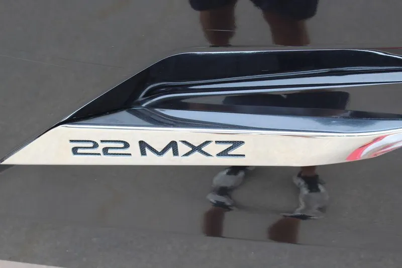 Slide: The Image of Close-up of 2012 Malibu Wakesetter 22 MXZ logo on a sleek black surface. - 10