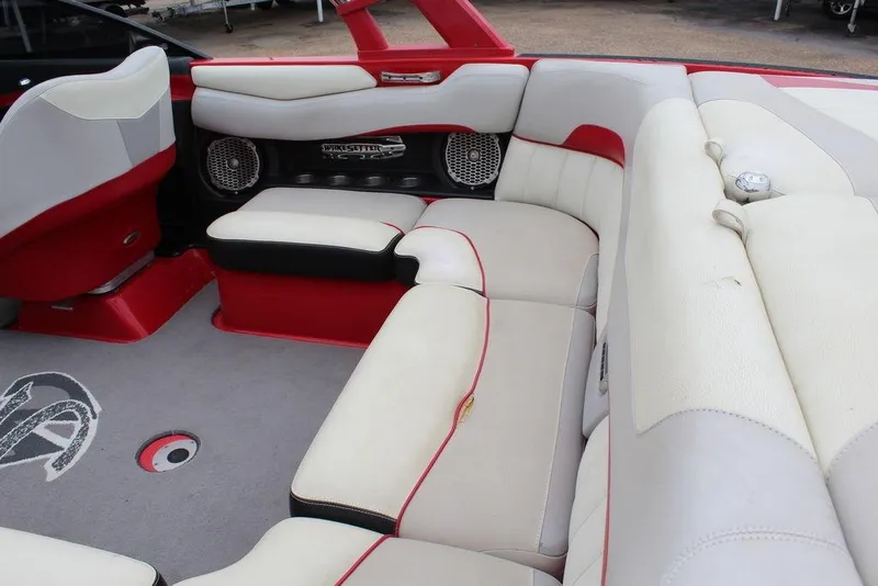 Slide: The Image of 2012 Malibu Wakesetter 22 MXZ interior with red and white seating and audio system. - 11