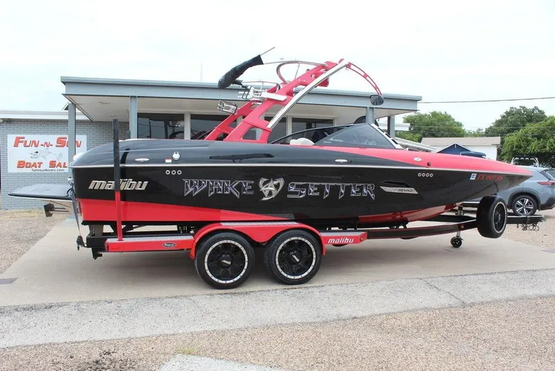 Slide: The Image of 2012 Malibu Wakesetter 22 MXZ boat on trailer at dealership. - 2