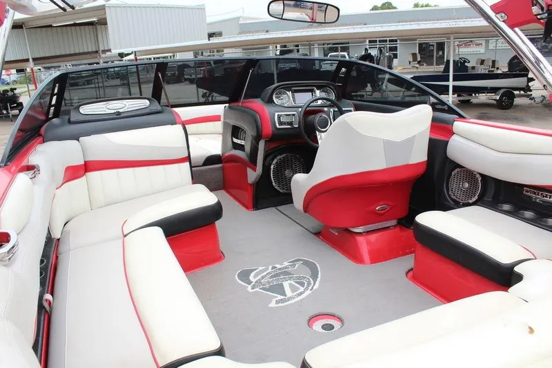 Slide: The Image of 2012 Malibu Wakesetter 22 MXZ interior with red and white seating, modern dashboard. - 3