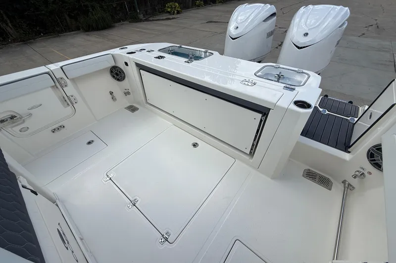 Slide: The Image of 2026 Cobia 305 Center Console boat deck with Yamaha engines, featuring storage and seating. - 10