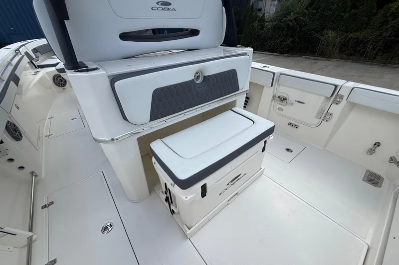 Slide: The Image of 2026 Cobia 305 Center Console boat interior with seating and storage features. - 12