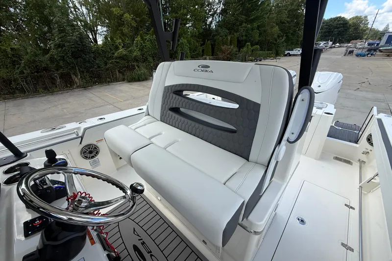 Slide: The Image of 2026 Cobia 305 Center Console boat interior with steering wheel and seating. - 15