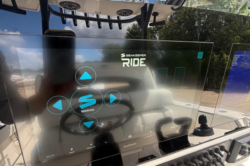 Slide: The Image of 2026 Cobia 305 Center Console with Seakeeper Ride control display. - 16