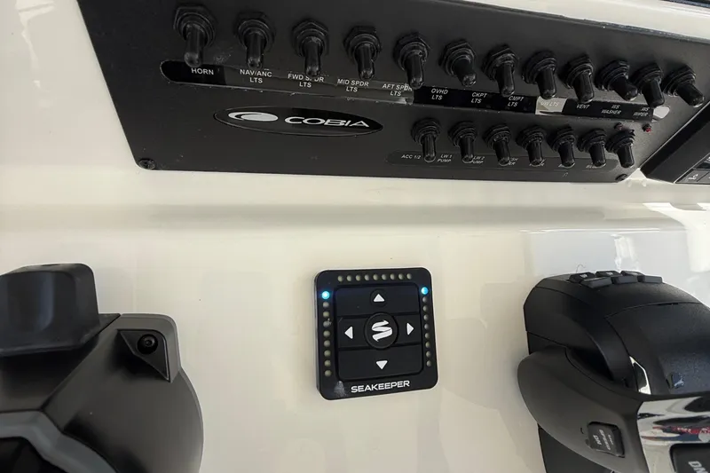Slide: The Image of Control panel of 2026 Cobia 305 Center Console boat with Seakeeper system. - 17