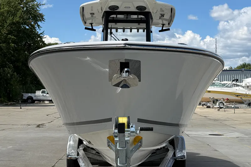Slide: The Image of 2026 Cobia 305 Center Console boat on trailer, front view, outdoors. - 2
