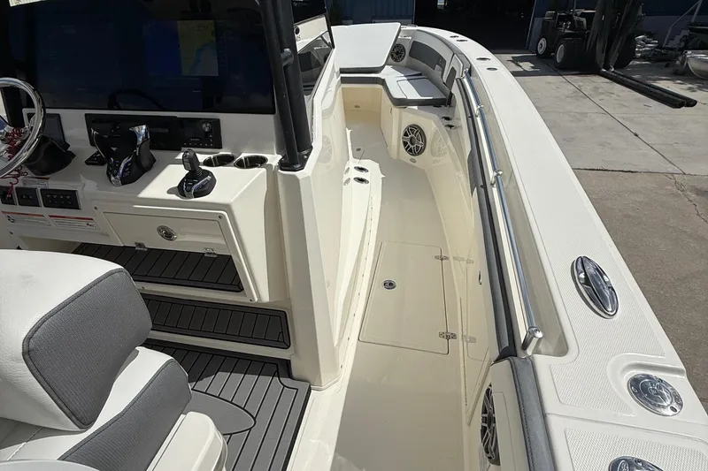 Slide: The Image of 2026 Cobia 305 Center Console boat interior with helm, seating, and storage compartments. - 21
