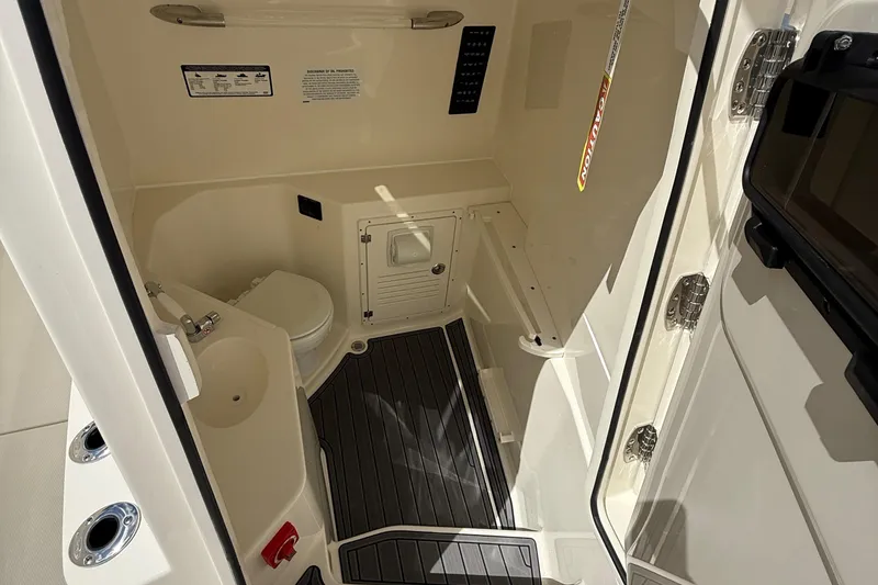 Slide: The Image of 2026 Cobia 305 Center Console interior with compact bathroom and modern fixtures. - 23
