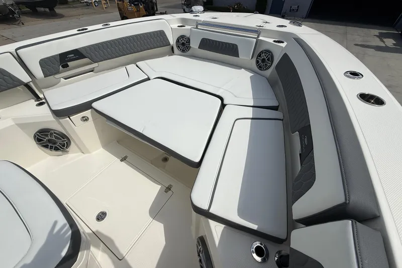 Slide: The Image of 2026 Cobia 305 Center Console boat interior with cushioned seating and storage compartments. - 27