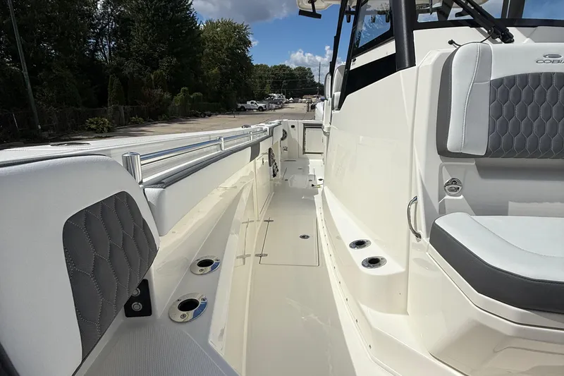 Slide: The Image of 2026 Cobia 305 Center Console boat interior with cushioned seating and sleek design. - 28