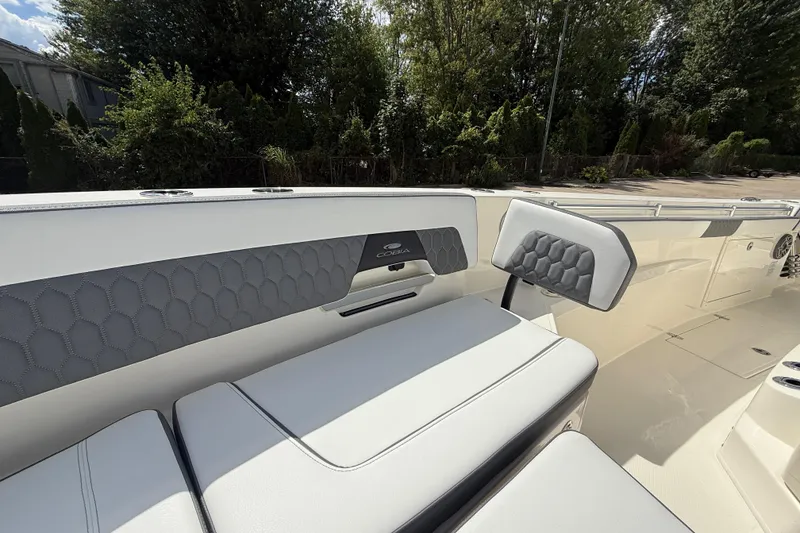 Slide: The Image of 2026 Cobia 305 Center Console boat interior with cushioned seating and sleek design. - 29