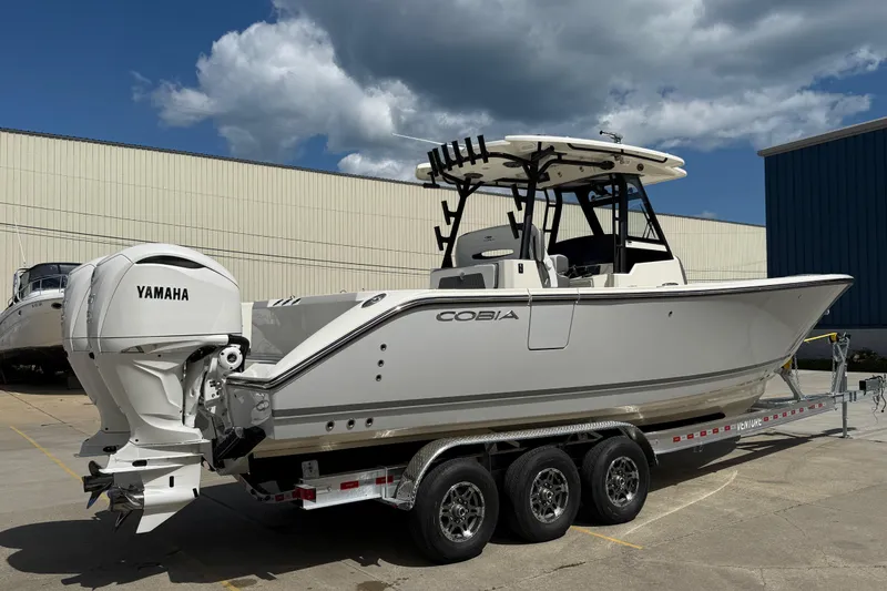 Slide: The Image of 2026 Cobia 305 Center Console boat with Yamaha engines on a trailer. - 3