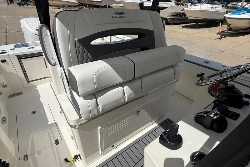 Slide: The Image of 2026 Cobia 305 Center Console boat interior with helm and seating. - 30
