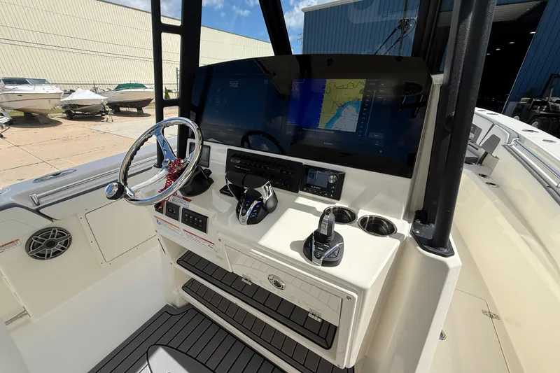 Slide: The Image of 2026 Cobia 305 Center Console helm with navigation display and controls. - 32