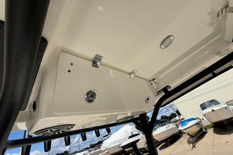 Slide: The Image of 2026 Cobia 305 Center Console boat interior view with storage and speakers. - 33