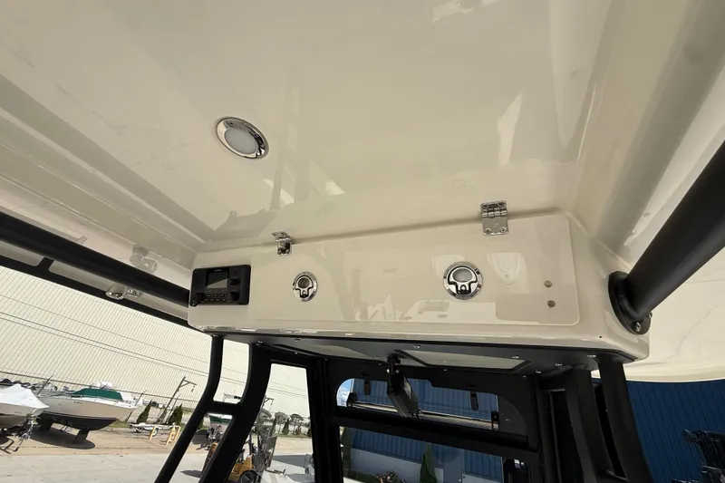Slide: The Image of 2026 Cobia 305 Center Console boat interior, featuring overhead console and controls. - 34