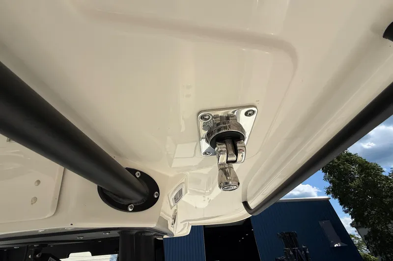 Slide: The Image of Close-up of 2026 Cobia 305 Center Console boat's T-top structure and hardware. - 35