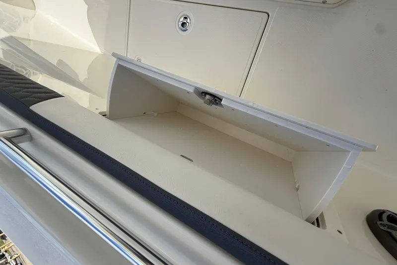 Slide: The Image of Storage compartment on a 2026 Cobia 305 Center Console boat, open and empty. - 36