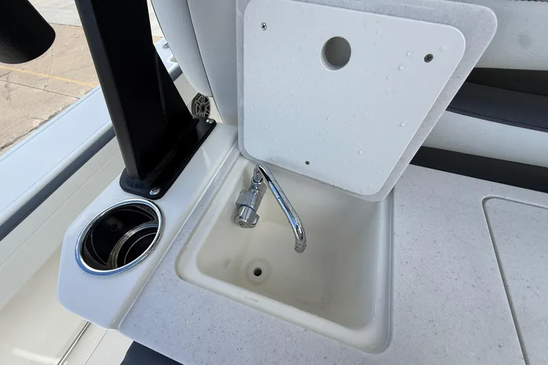 Slide: The Image of Cobia 305 Center Console 2026 boat sink with faucet and cup holder. - 43