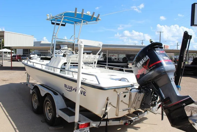 Slide: The Image of 2002 Blue Wave 2200 DELUXE CC boat on trailer with Yamaha outboard motor. - 8