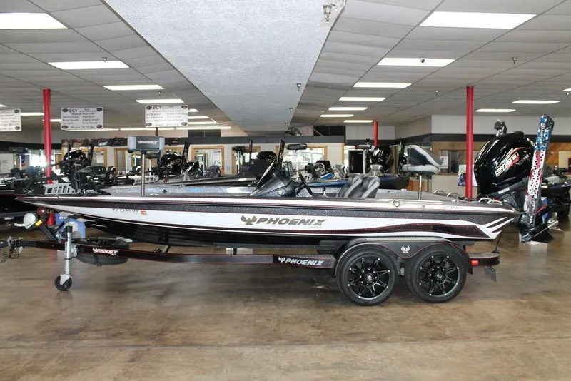 Slide: The Image of 2024 Phoenix 921 ELITE boat displayed indoors on a trailer. - 1