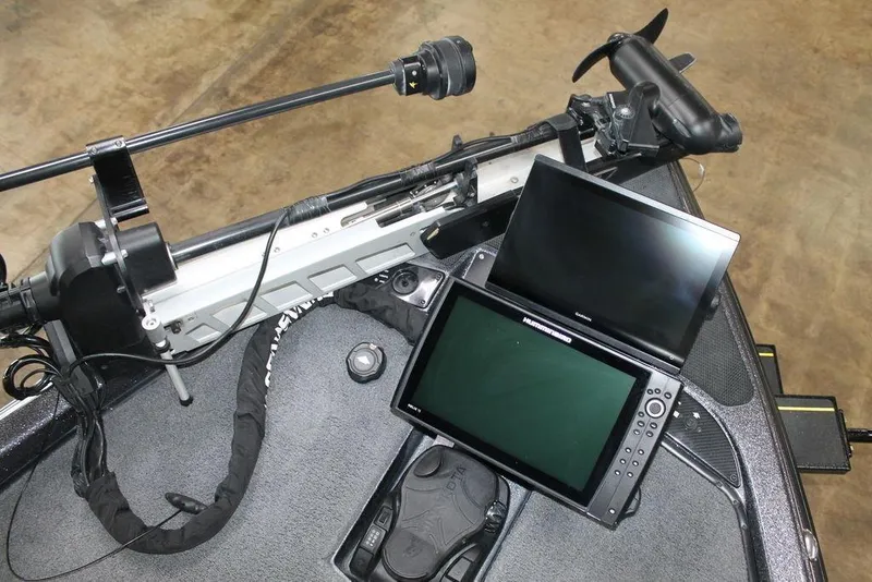 Slide: The Image of 2024 Phoenix 921 ELITE boat dashboard with advanced navigation screens and controls. - 11