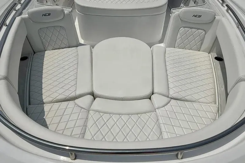 Slide: The Image of Luxurious seating on 2025 HCB 48 Campeon boat with quilted white upholstery. - 11