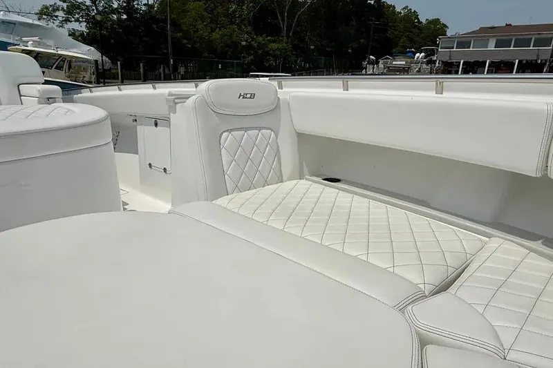 Slide: The Image of 2025 HCB 48 Campeon boat interior with luxurious white quilted seating. - 12