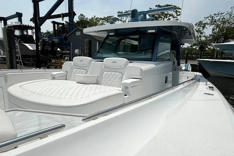 Slide: The Image of 2025 HCB 48 Campeon luxury boat with white seating and sleek design. - 14