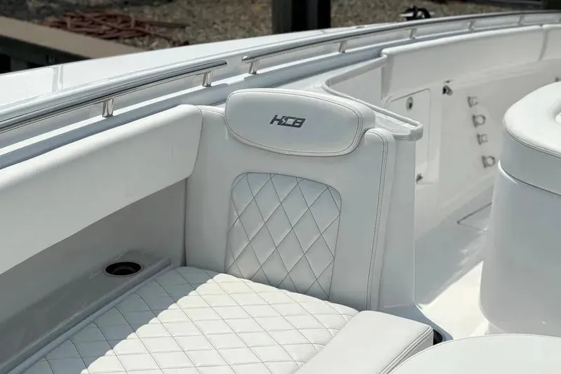 Slide: The Image of Luxury seating on 2025 HCB 48 Campeon boat with quilted design and logo. - 19