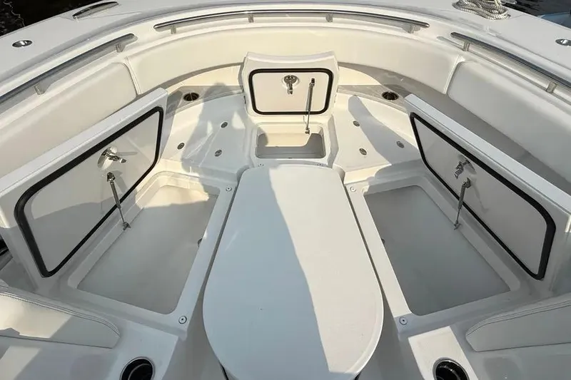 Slide: The Image of 2025 HCB 48 Campeon boat interior with open storage compartments and seating area. - 2