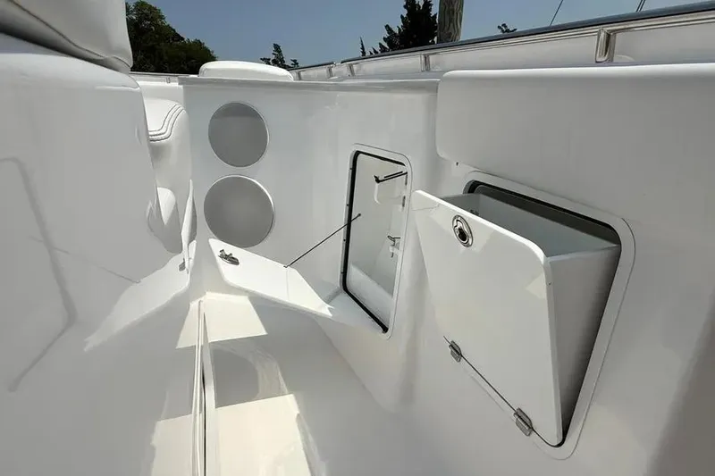 Slide: The Image of 2025 HCB 48 Campeon boat interior with storage compartments and sleek white design. - 20