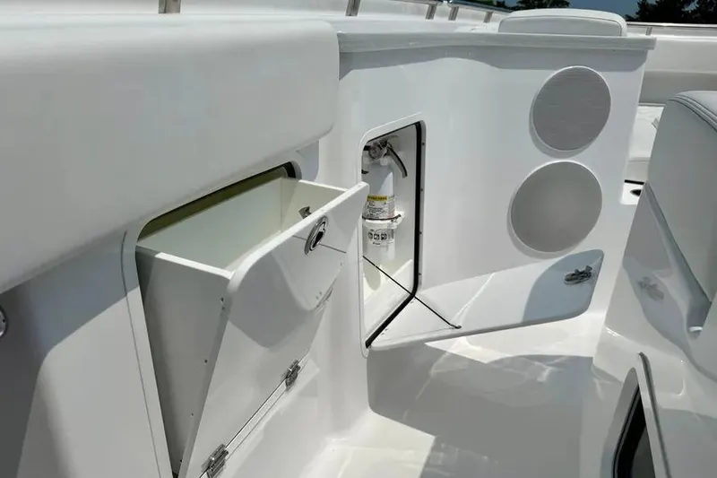 Slide: The Image of 2025 HCB 48 Campeon boat interior with storage compartments and fire extinguisher. - 22