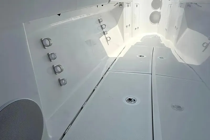 Slide: The Image of 2025 HCB 48 Campeon boat interior with sleek white design and modern fixtures. - 26