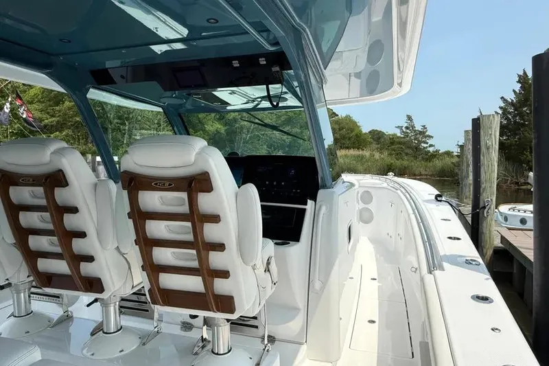 Slide: The Image of 2025 HCB 48 Campeon boat interior with white seating and modern dashboard. - 31