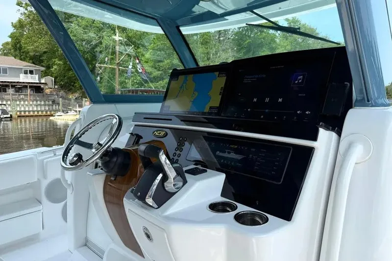 Slide: The Image of Helm of 2025 HCB 48 Campeon boat with advanced navigation displays. - 32