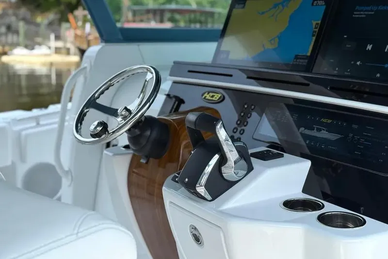 Slide: The Image of Helm of 2025 HCB 48 Campeon boat with modern controls and navigation screens. - 33