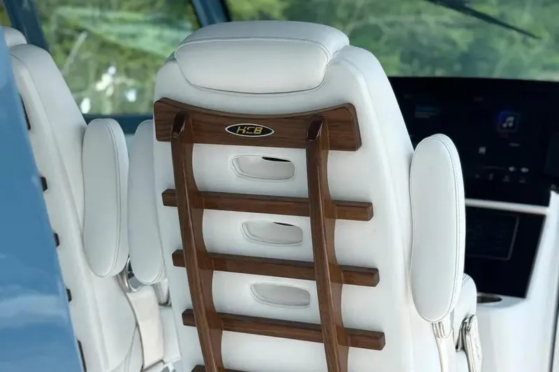 Slide: The Image of Luxury seating in 2025 HCB 48 Campeon boat, featuring elegant wood and leather design. - 34