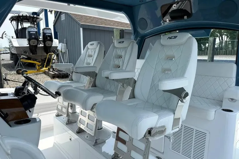 Slide: The Image of Luxury seating on 2025 HCB 48 Campeon boat, featuring white leather and modern design. - 35
