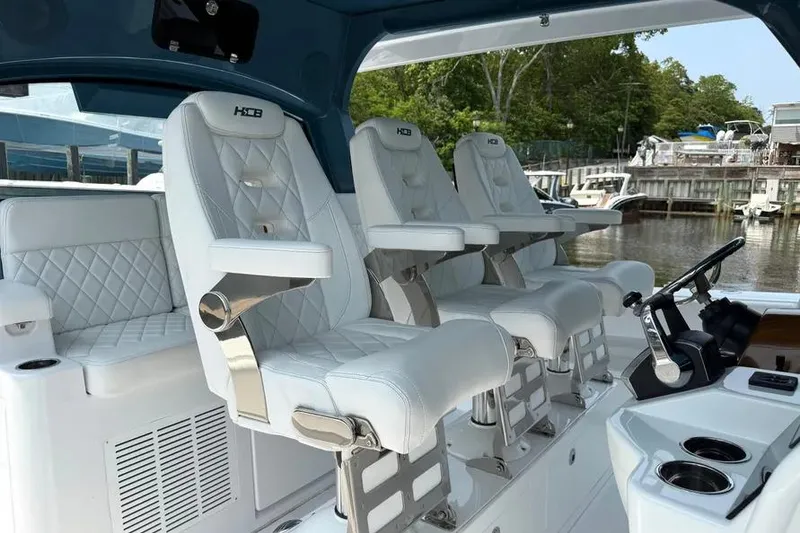 Slide: The Image of Luxury seating on 2025 HCB 48 Campeon boat, featuring white leather and sleek design. - 36