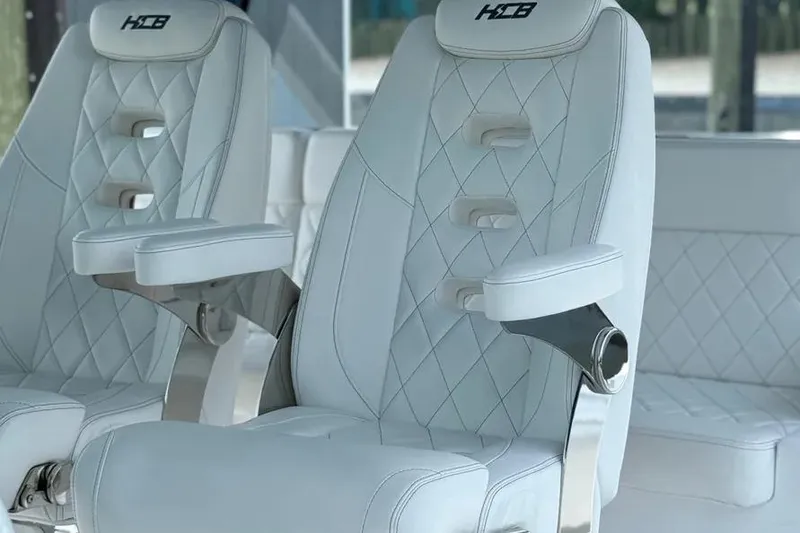 Slide: The Image of Luxury seating on 2025 HCB 48 Campeon boat with white diamond-stitched upholstery. - 38