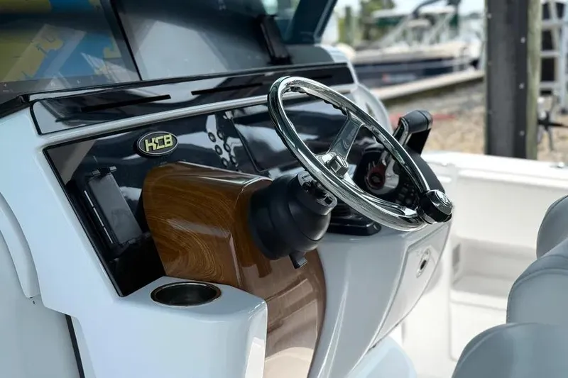 Slide: The Image of Steering wheel of 2025 HCB 48 Campeon boat, featuring sleek design and wood accents. - 39