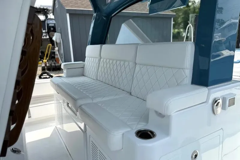 Slide: The Image of Luxurious seating on 2025 HCB 48 Campeon boat with quilted white upholstery. - 40