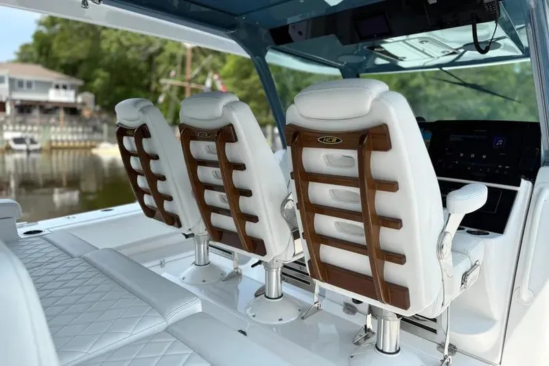 Slide: The Image of Luxury seating on 2025 HCB 48 Campeon boat, featuring elegant white and wood design. - 41